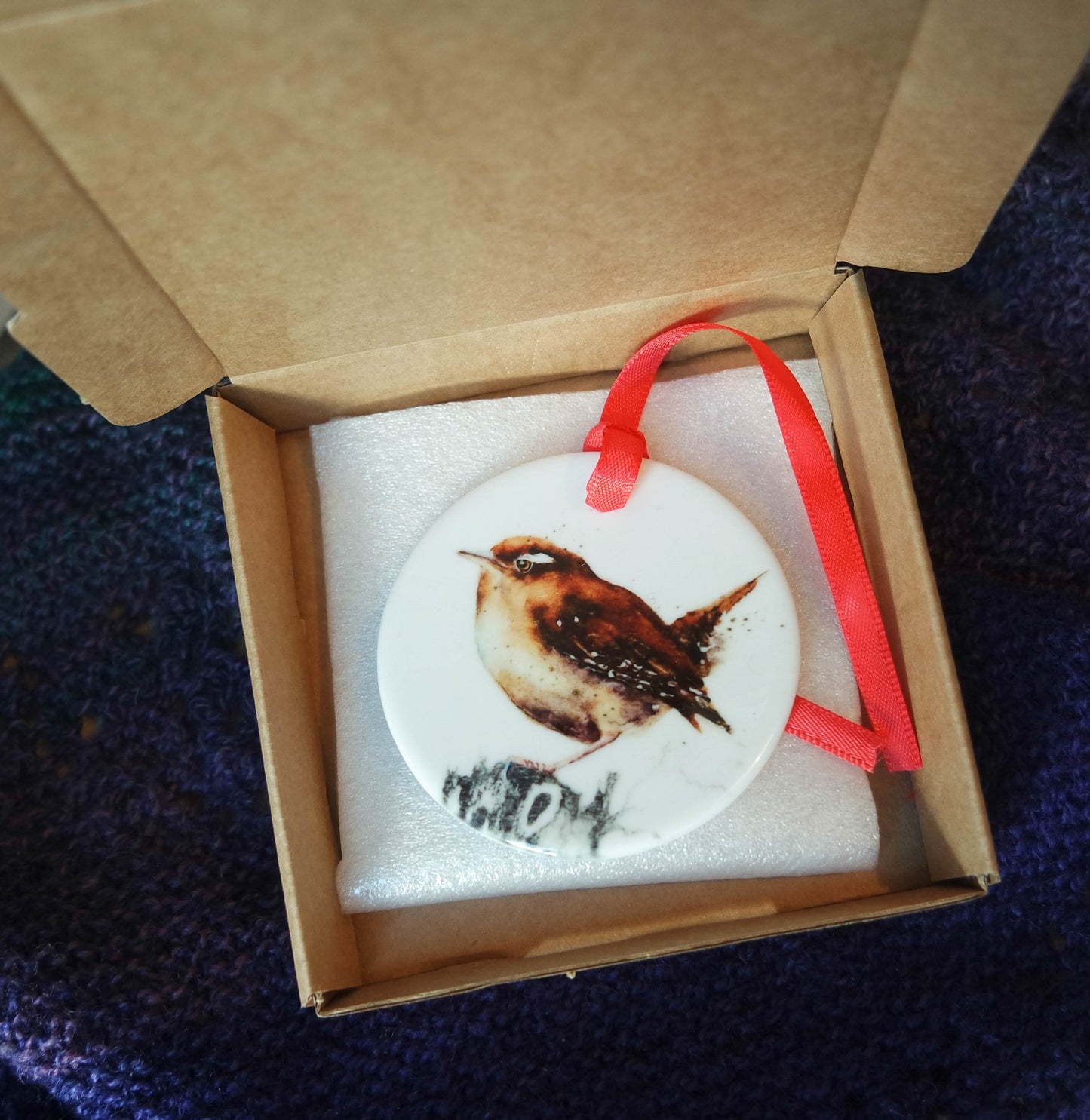 'Little Wren' a beautiful ceramic hanging decoration  with a red ribbon